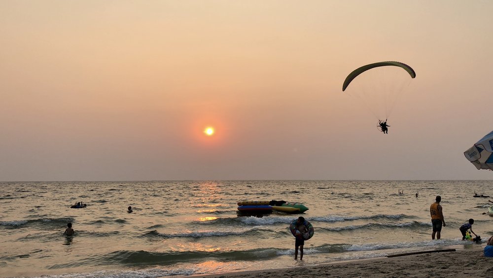 People doing water activities on Bangsaen Beach in Thailand