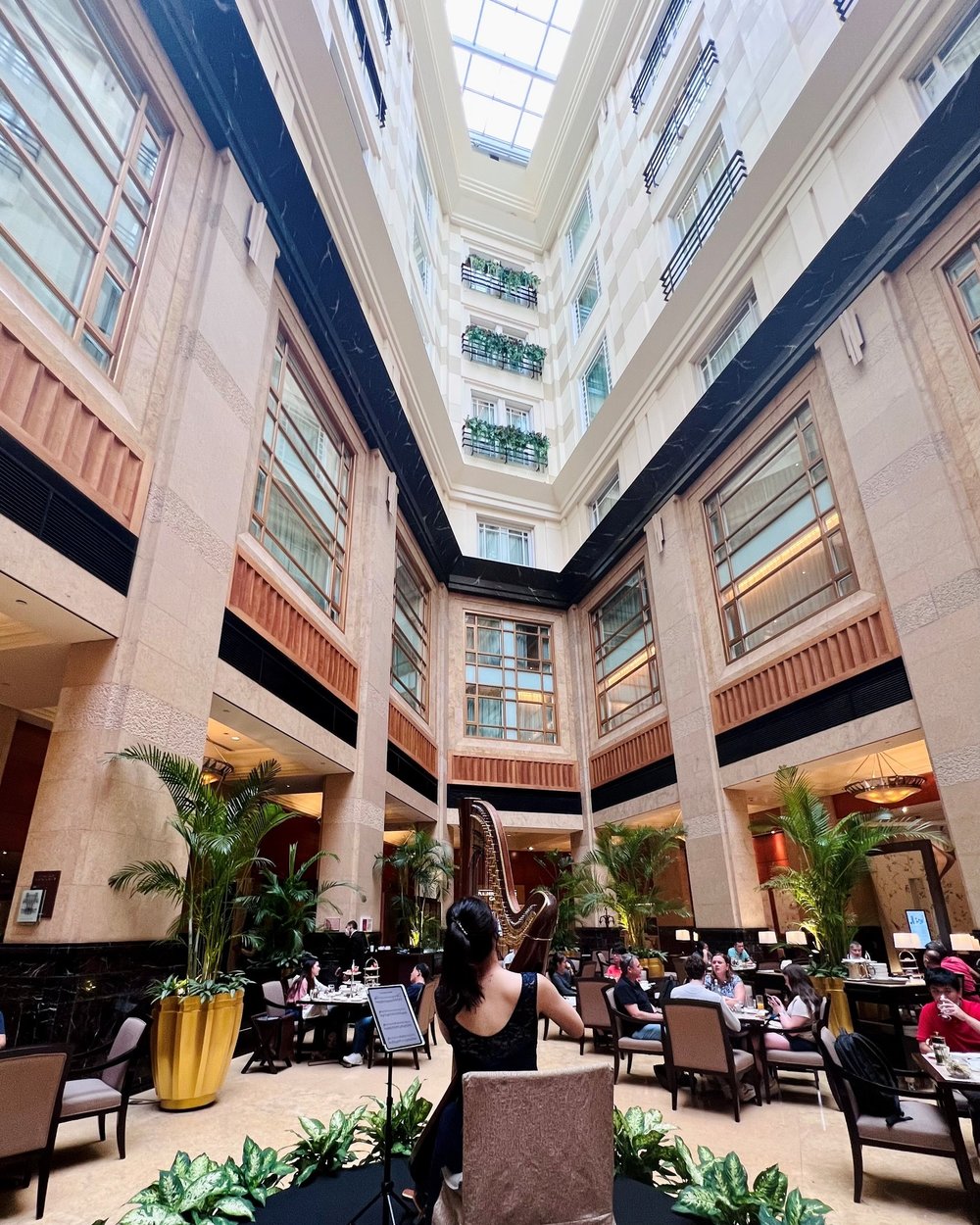 People dining in a restaurant with a high ceiling