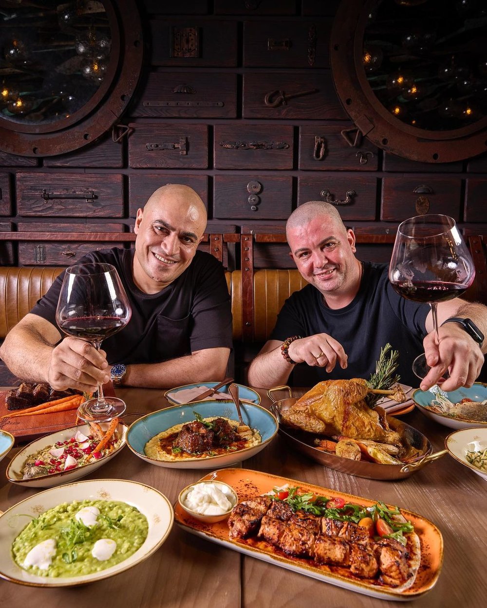 Two people holding a wine glass