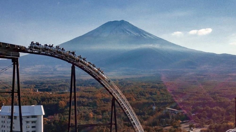 Enjoy the thrilling rollercoaster amidst the backdrop of Mount Fuji