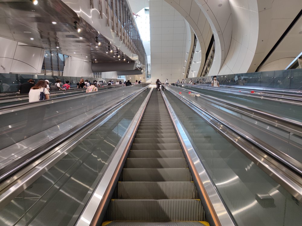 People holding at escalator