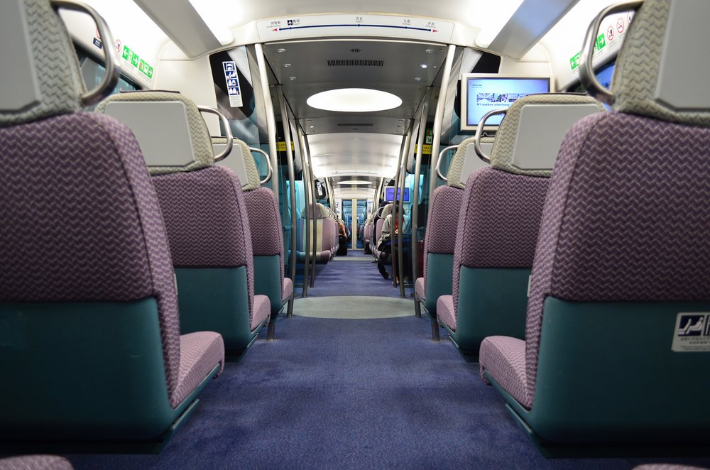 Green and purple seats inside an airplane 