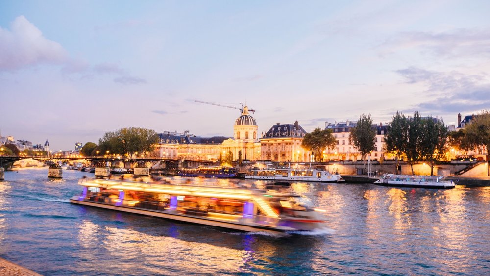 a boat cruising down the Seine