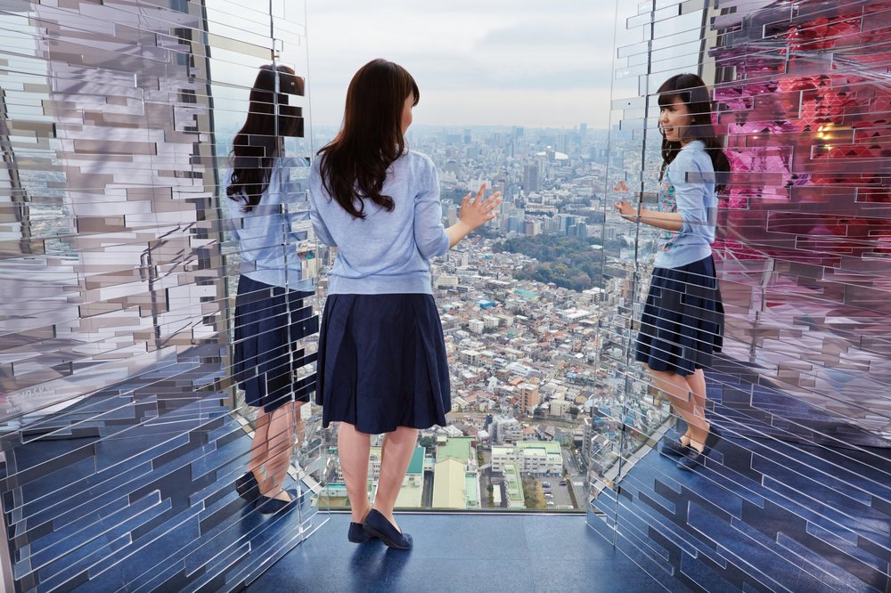 Girl on an observatory deck inside Sky Circus Sunshine 60 Observatory