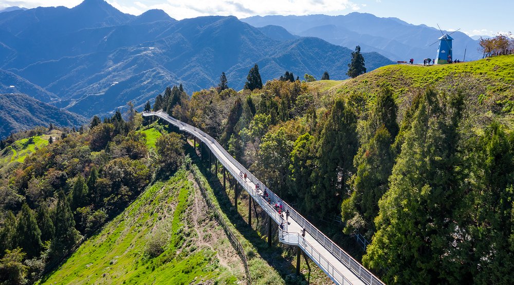Vast green grasslands and a long bridge