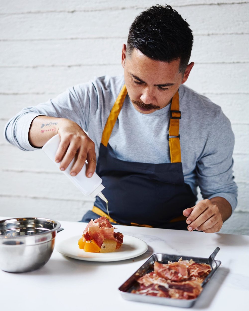 Josh Boutwood seasoning the meat