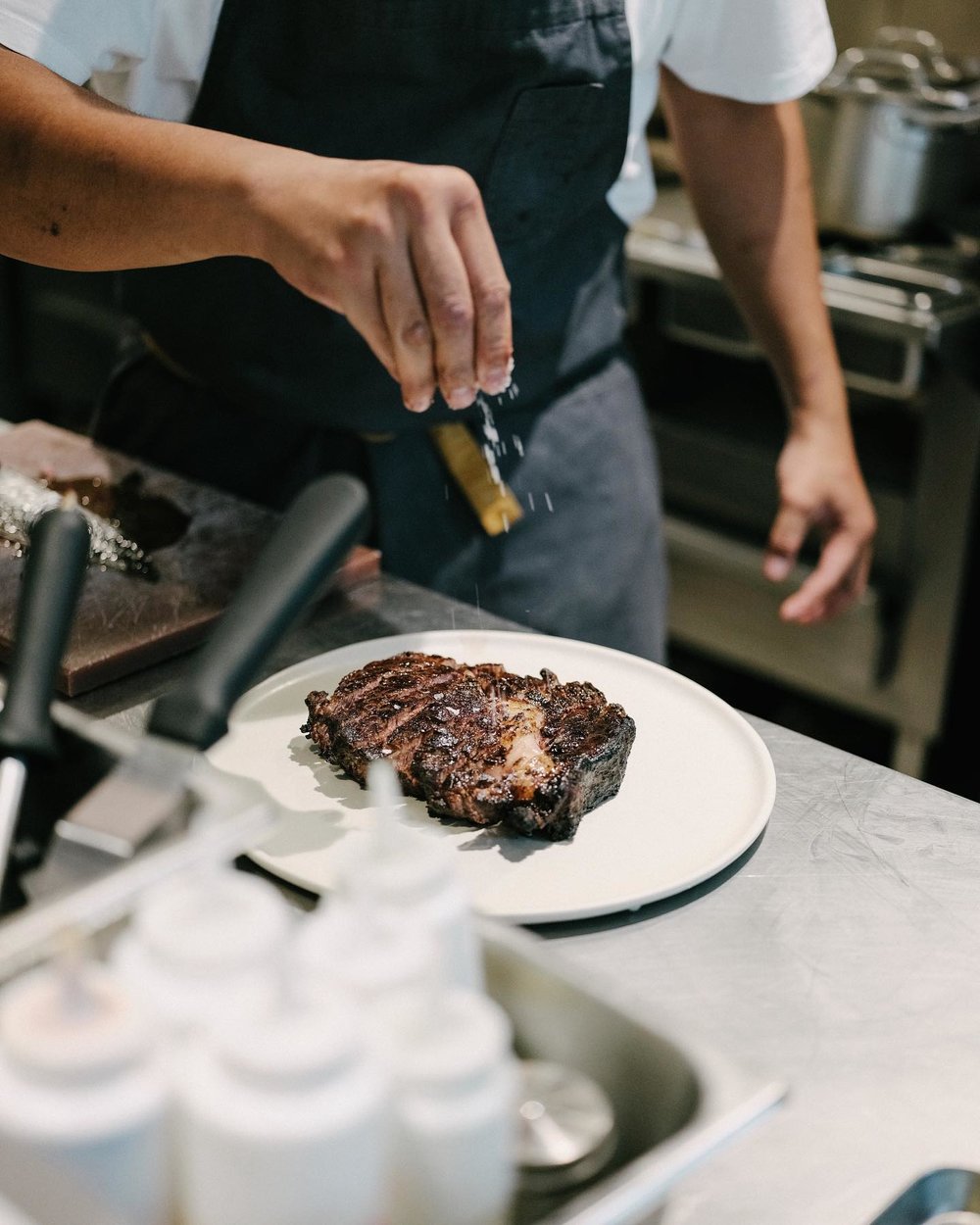 Man adding salt in steak