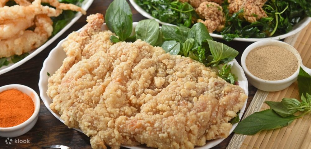 Popcorn chicken on a plate with gravy beside it