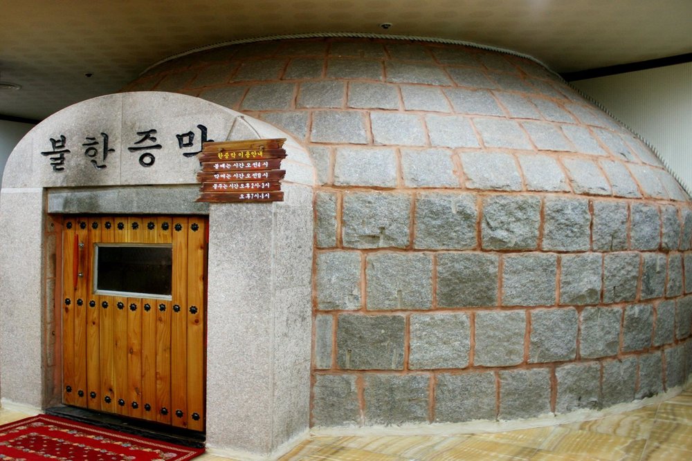 Cemented bath house with a wooden door