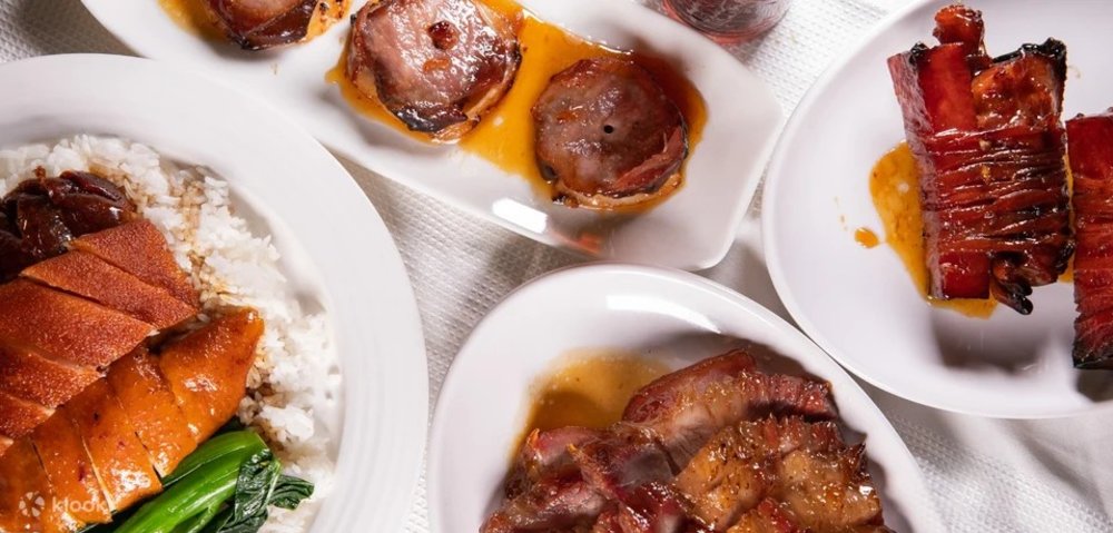 A variety of pork and chicken dishes on a table