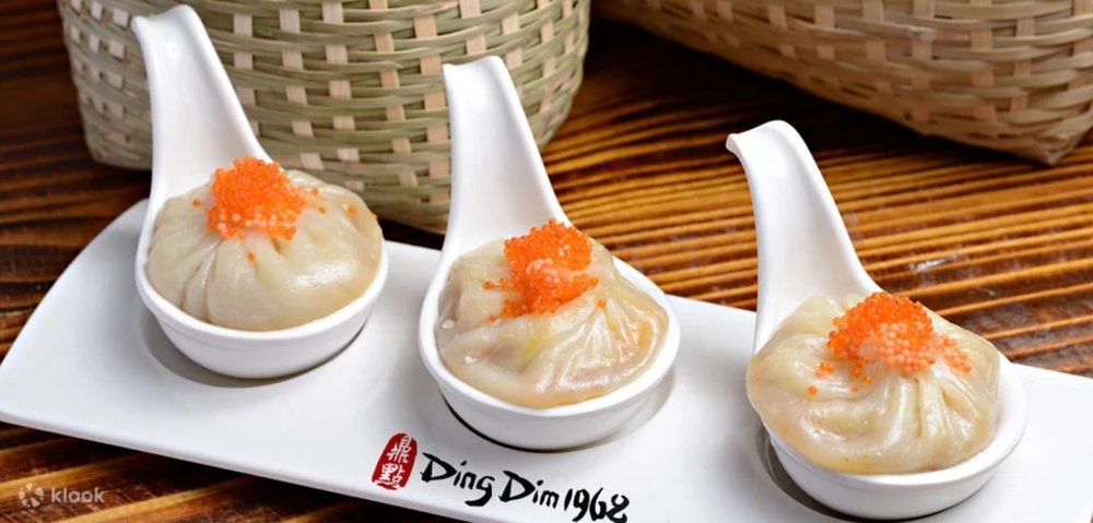 Three soup dumplings set on ladles