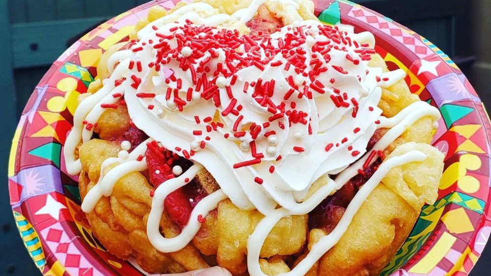 Enjoy the sugar rush from these loaded funnel cakes! Credits to @whimsicaldisneyventure