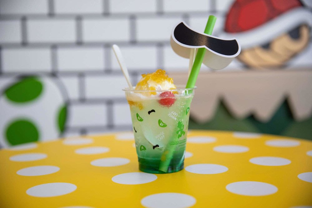 Green Mario-themed drink on a table