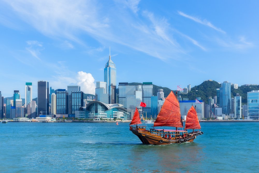 A red boat sailing in Hong Kong