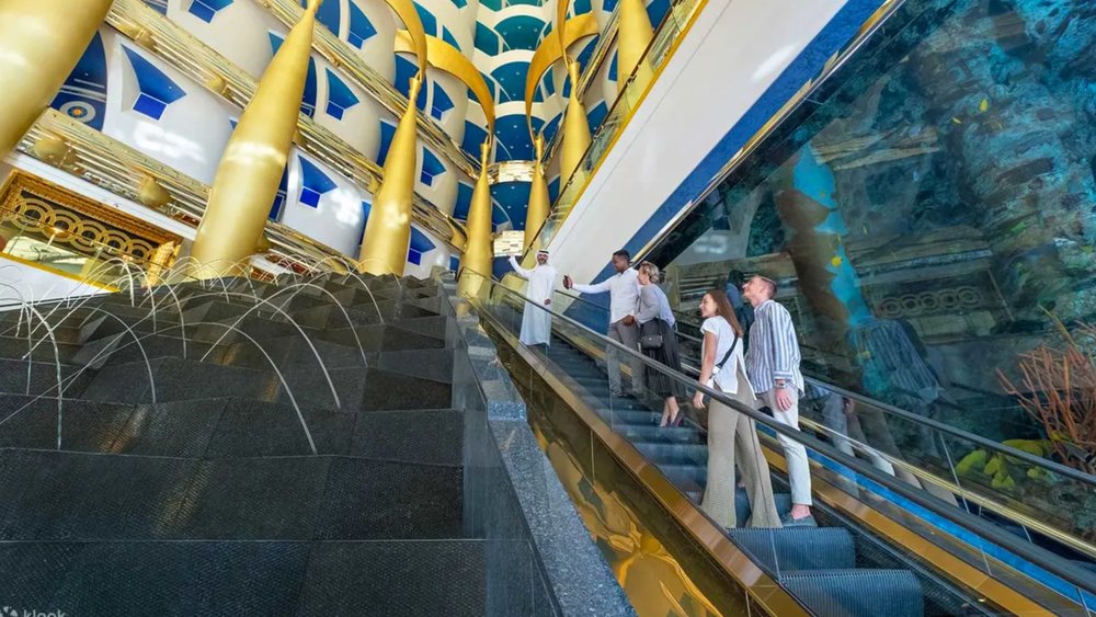 people going up the escalator inside Burj Al Arab