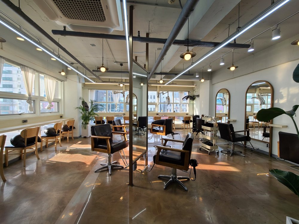 Seats and mirrors inside a nail and hair salon