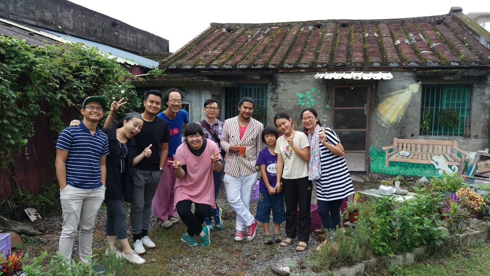 A group of people posing for a photo in a garden