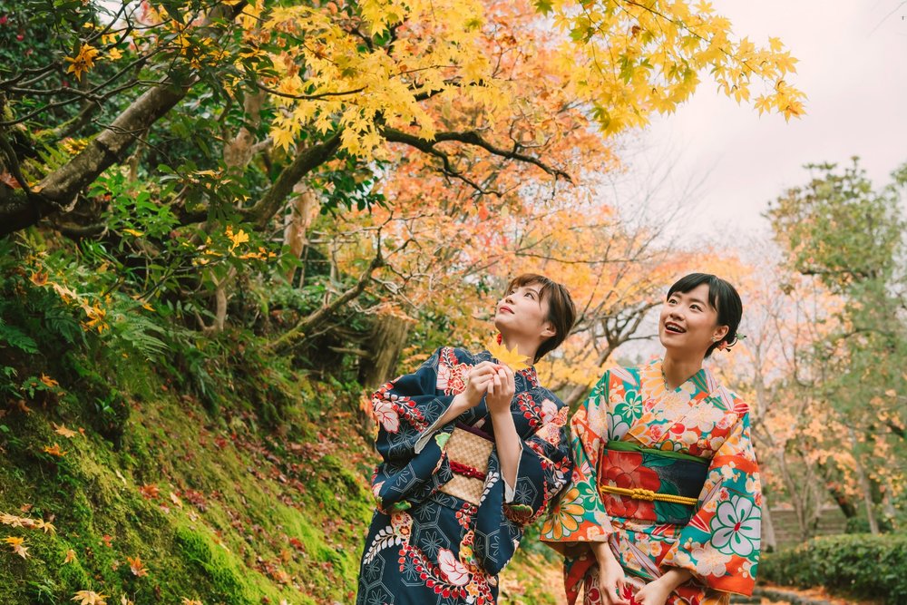 two women wearing kimonos in the fall