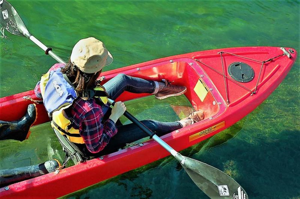 girl rowing a clear kayak