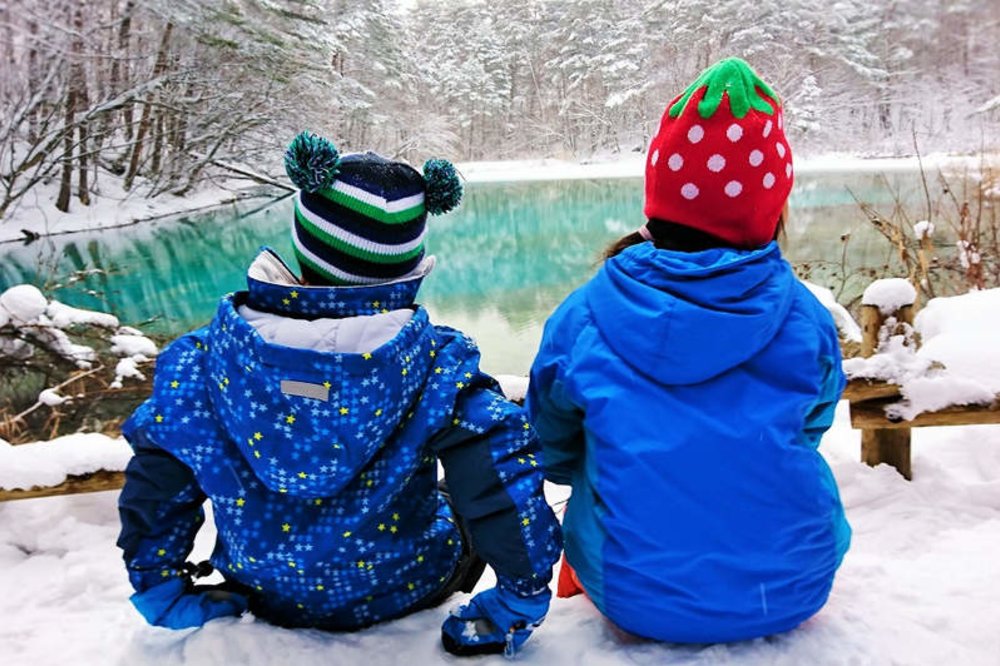 children looking at frozen pond