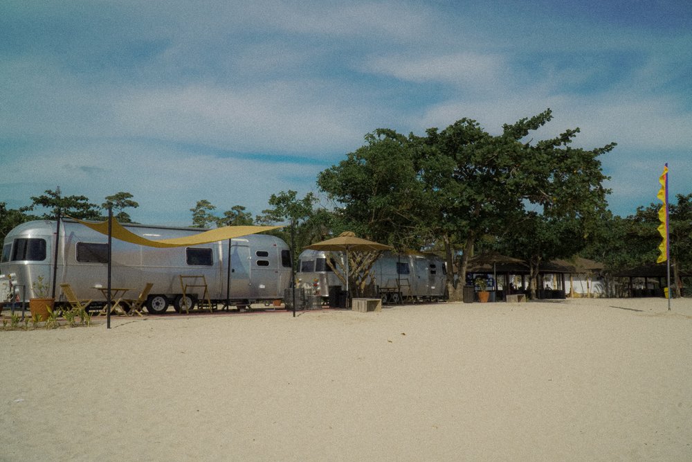 silver camper vans by the beach