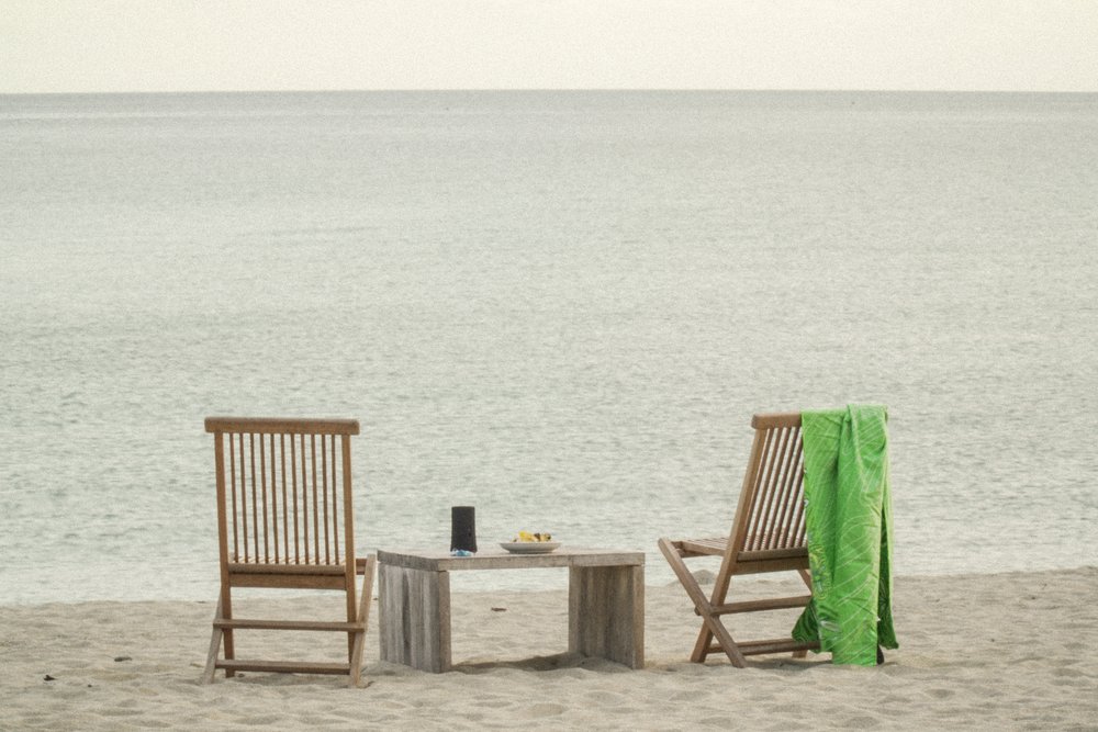 wooden chairs by seashore