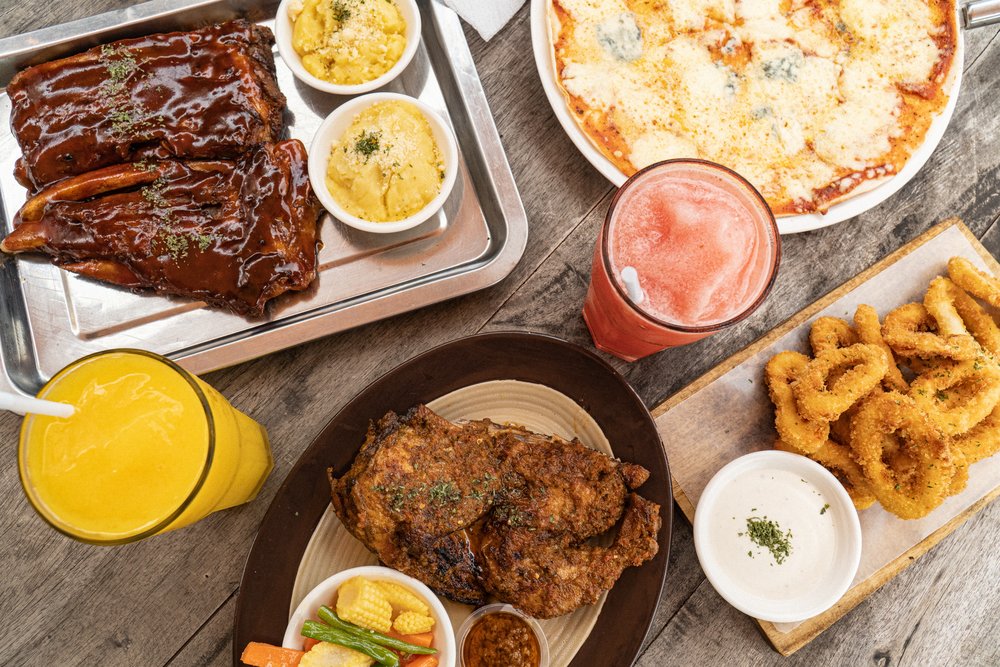 flat lay of ribs pizza and chicken