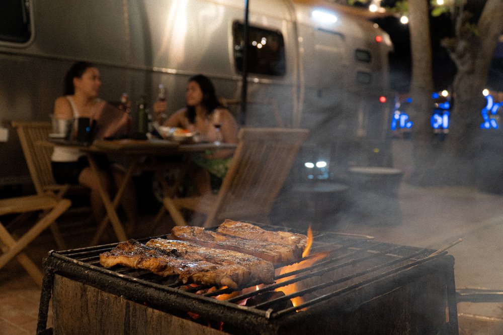 barbeque grill and two girls in the background