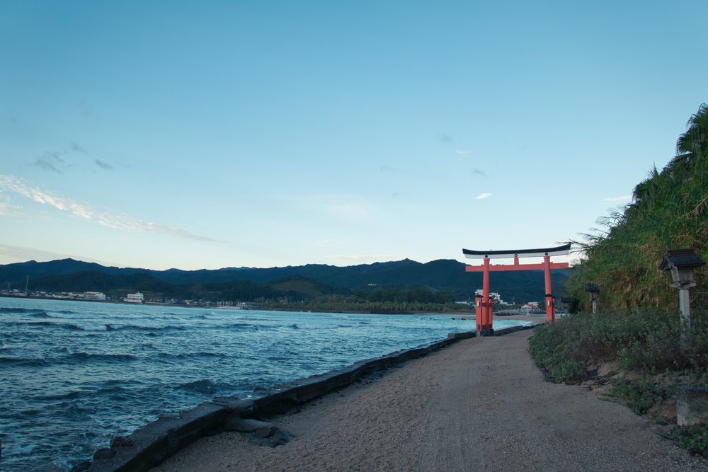 Torii gate on a road in Fukuoka by the sea