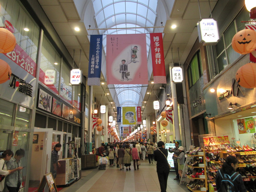 a shopping area with shops lined left and right