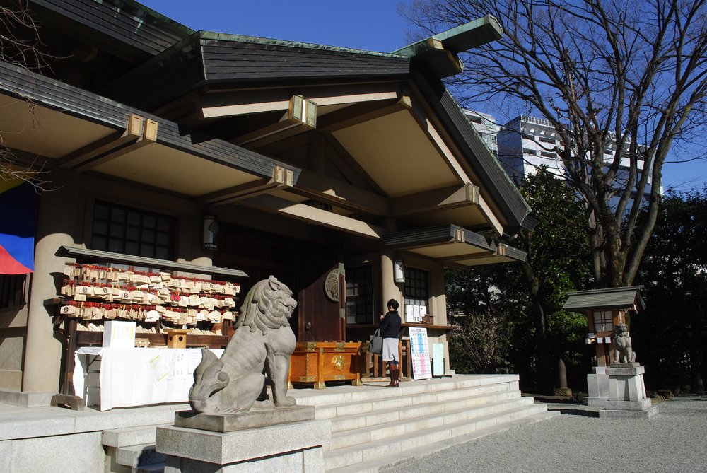 woman in front of shrine shop