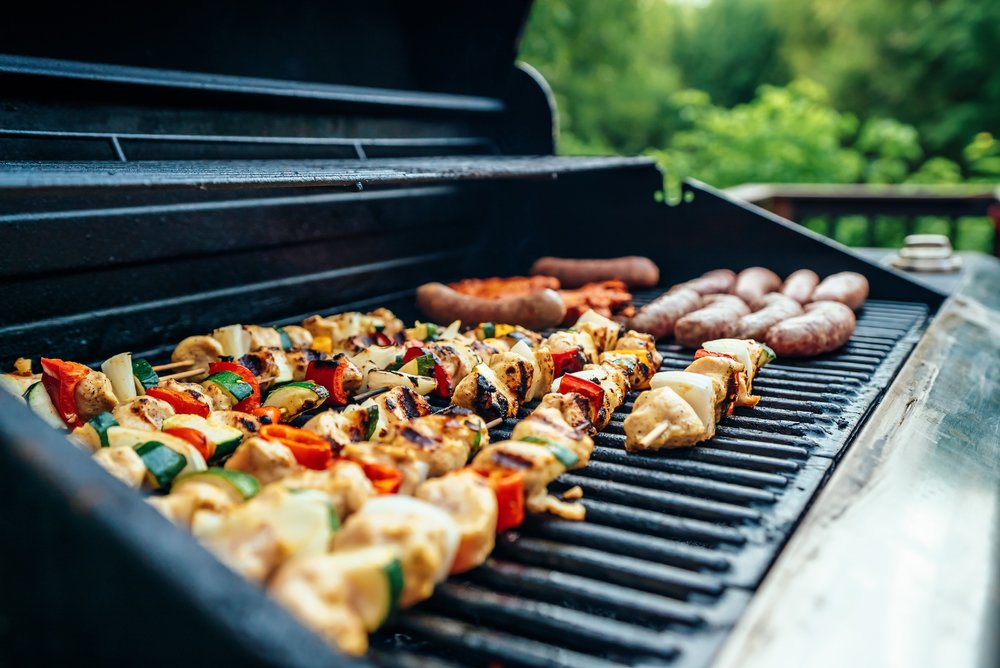 skewers and sausages on a barbecue grill