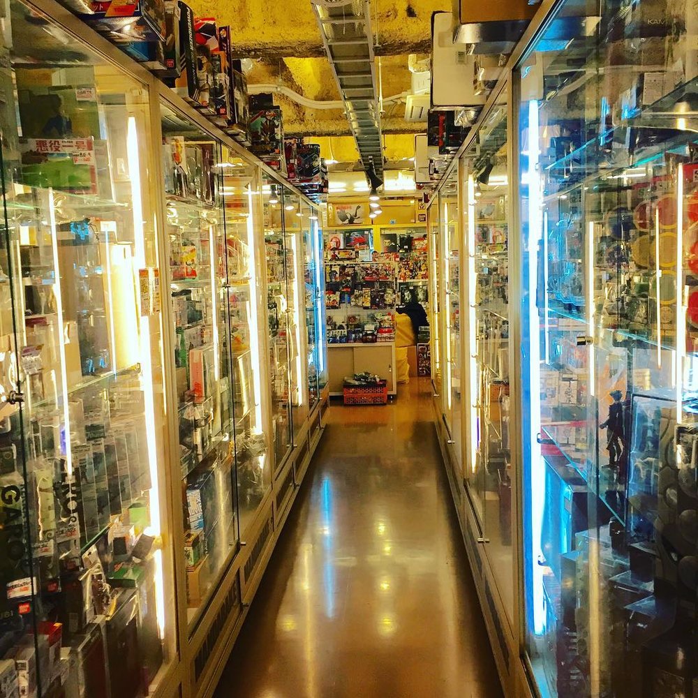 glass cabinets filled with figurines and other anime goods