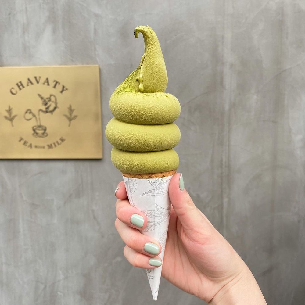 woman holding cup of green tea