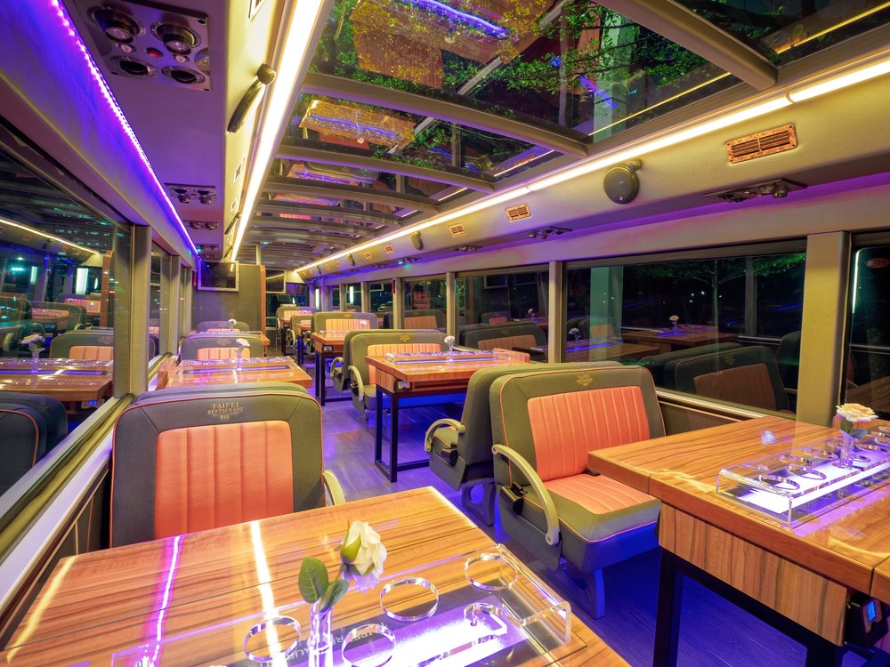 Seats and tables set up inside a bus