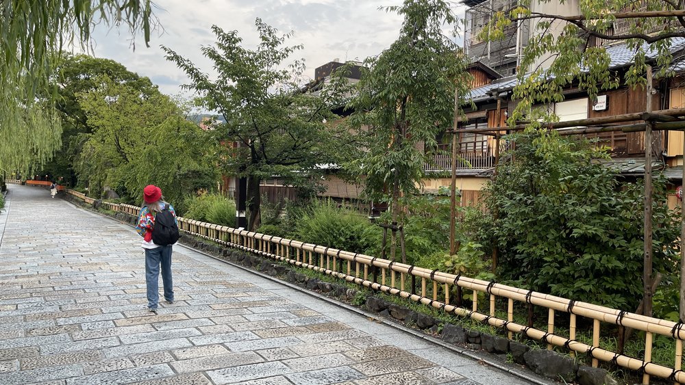 lady walking along cobbled streets in kyoto