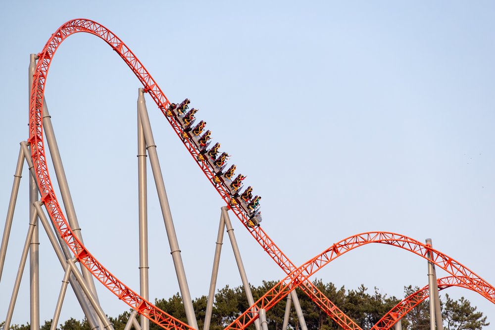 People on a roller coaster in a theme park