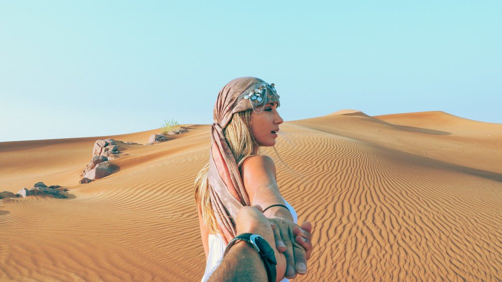 blonde woman in dubai dessert
