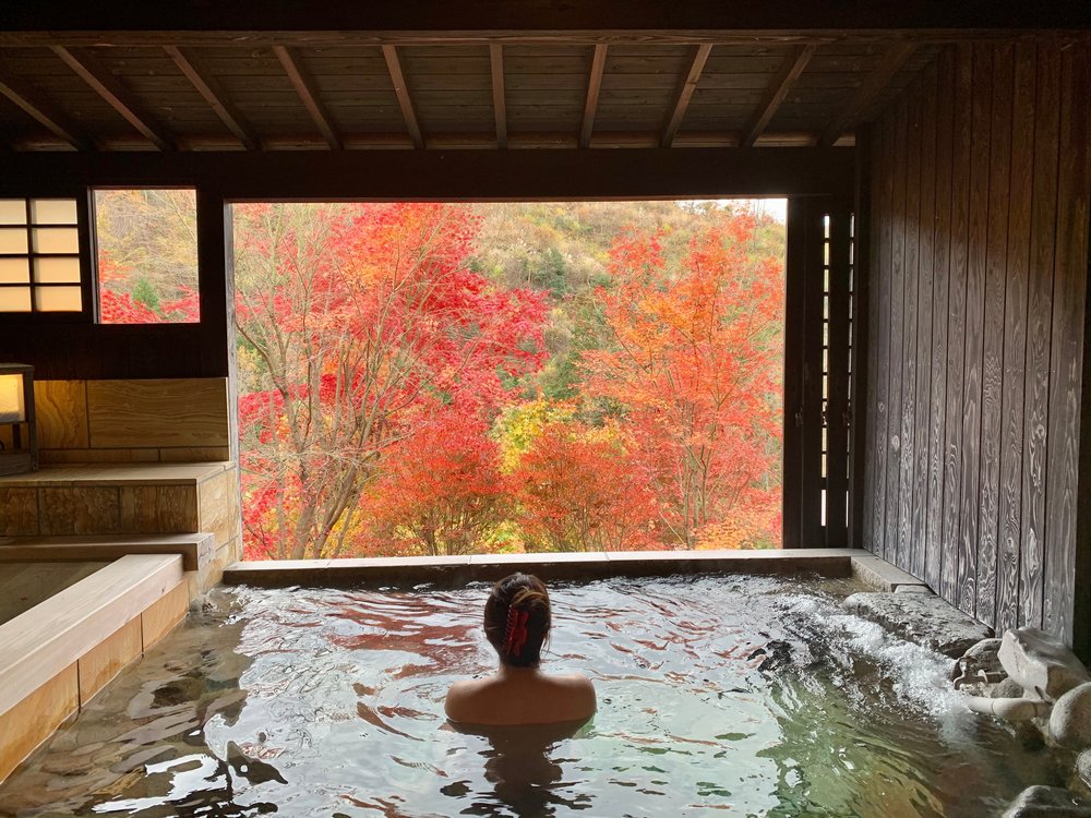 woman in onsen overlooking nature