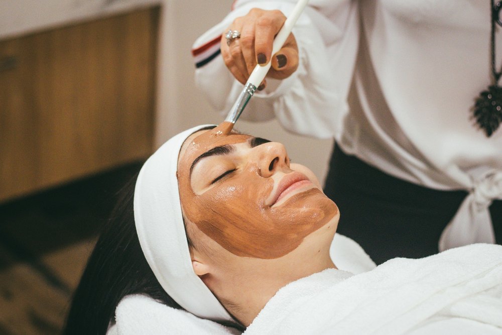 woman getting a mud mask facial treatment