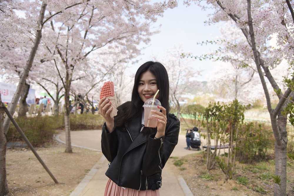Girl holding a pink snack and drink