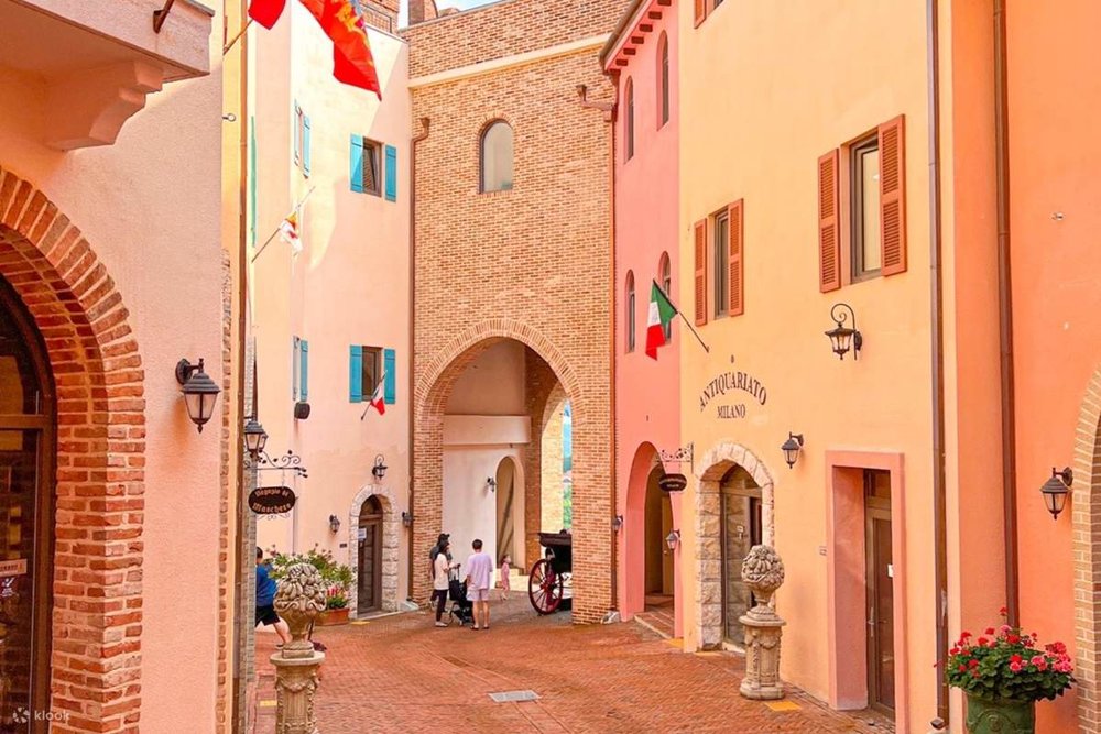 people walking along cobblestone road
