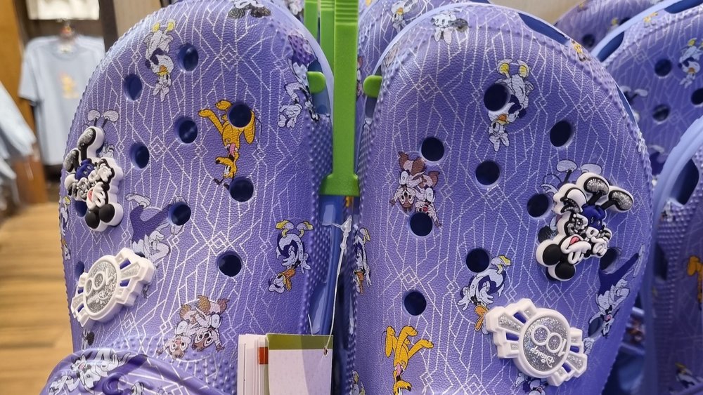 Keep it 100 with Disney100 Crocs.
