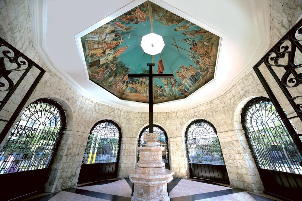 Magellan's Cross surrounded with paintings of battle of mactan