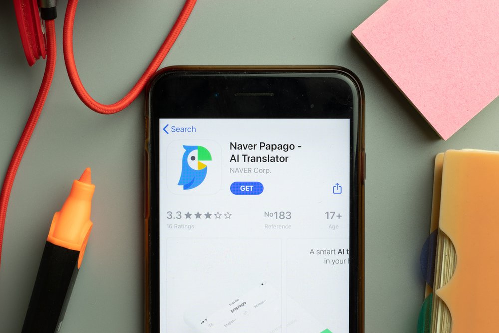 Phone screen close-up with Naver Papago AI Translator mobile app logo on display, Illustrative Editorial