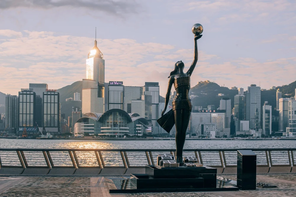 Statue holding a ball with the view of metropolis