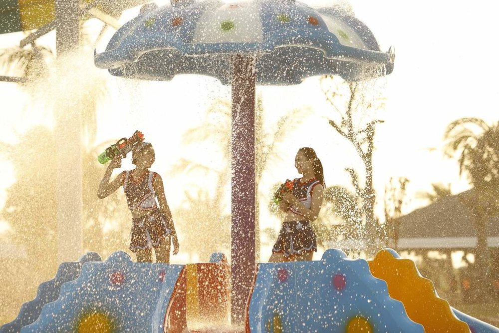 two people splashing in a water park