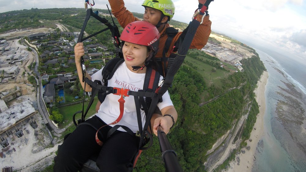 woman on a paragliding ride during the day time