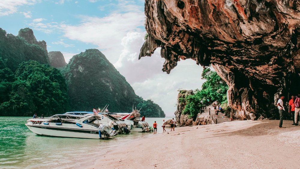 people docking off a boat on an island