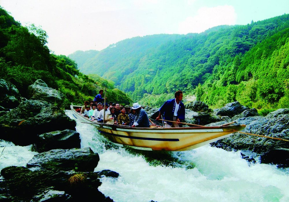Tourist riding a boat in river rapids